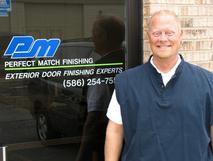 A man standing in front of a window.