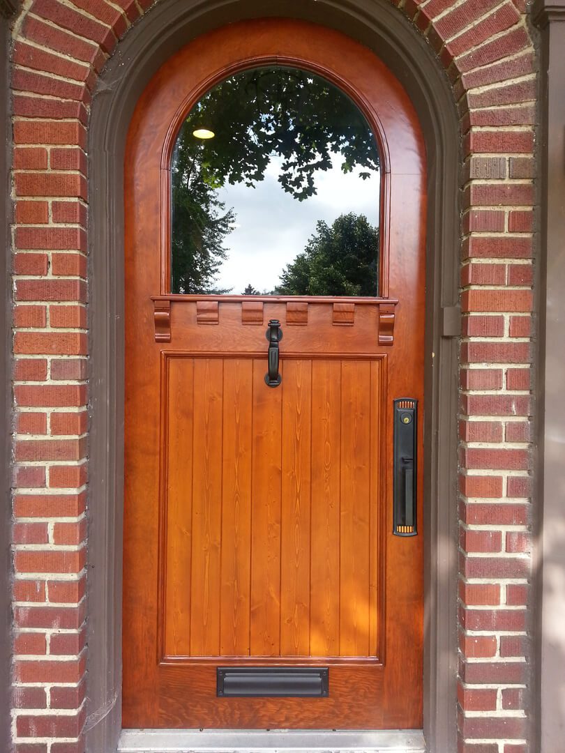 A door with a wooden frame and a window.